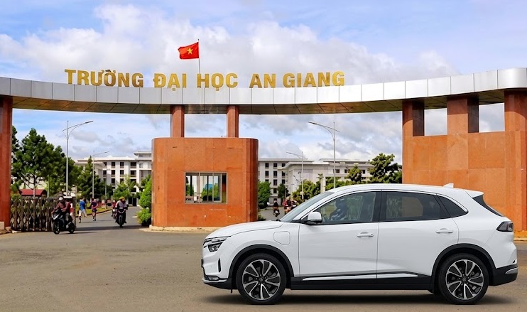 Xe taxi điện trắng trước Trường Đại học An Giang, Long Xuyên